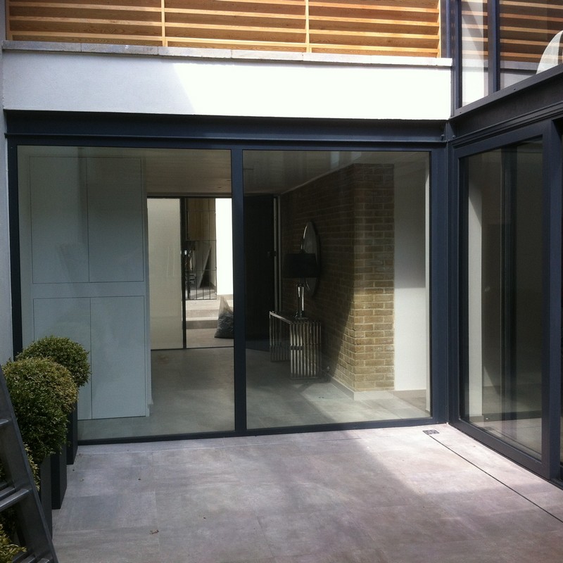 Floor-to-ceiling sliding doors opening to courtyard in Chiswick