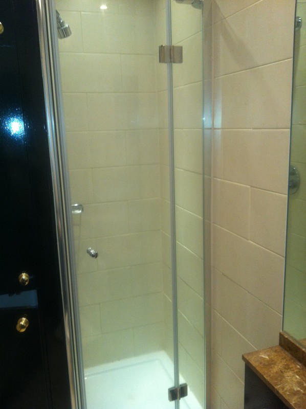 Frameless glass shower enclosure with chrome fittings in Chiswick