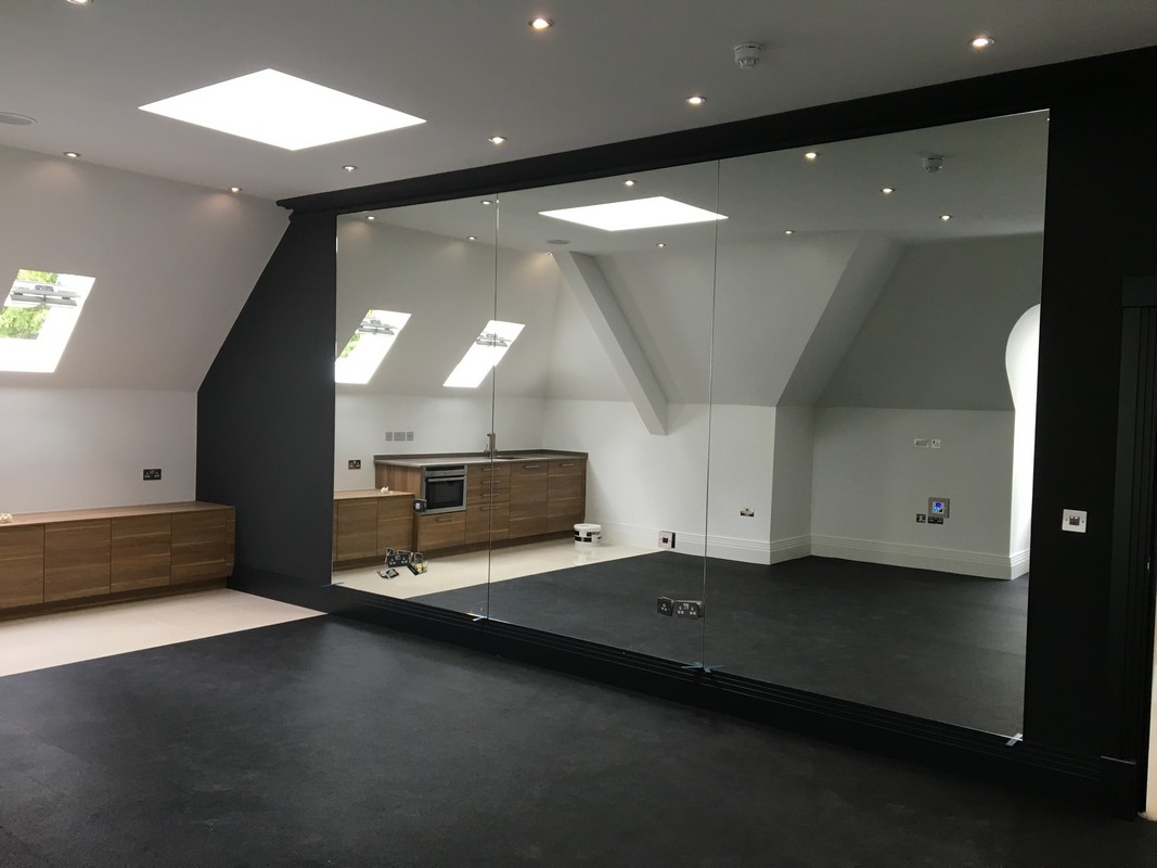 Frameless glass wall dividing loft conversion in Chiswick