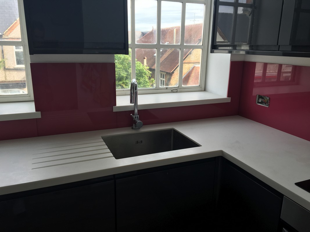 Deep plum coloured glass splashback in modern Chiswick kitchen