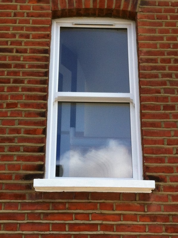 uPVC sash window on Victorian red brick house in Chiswick
